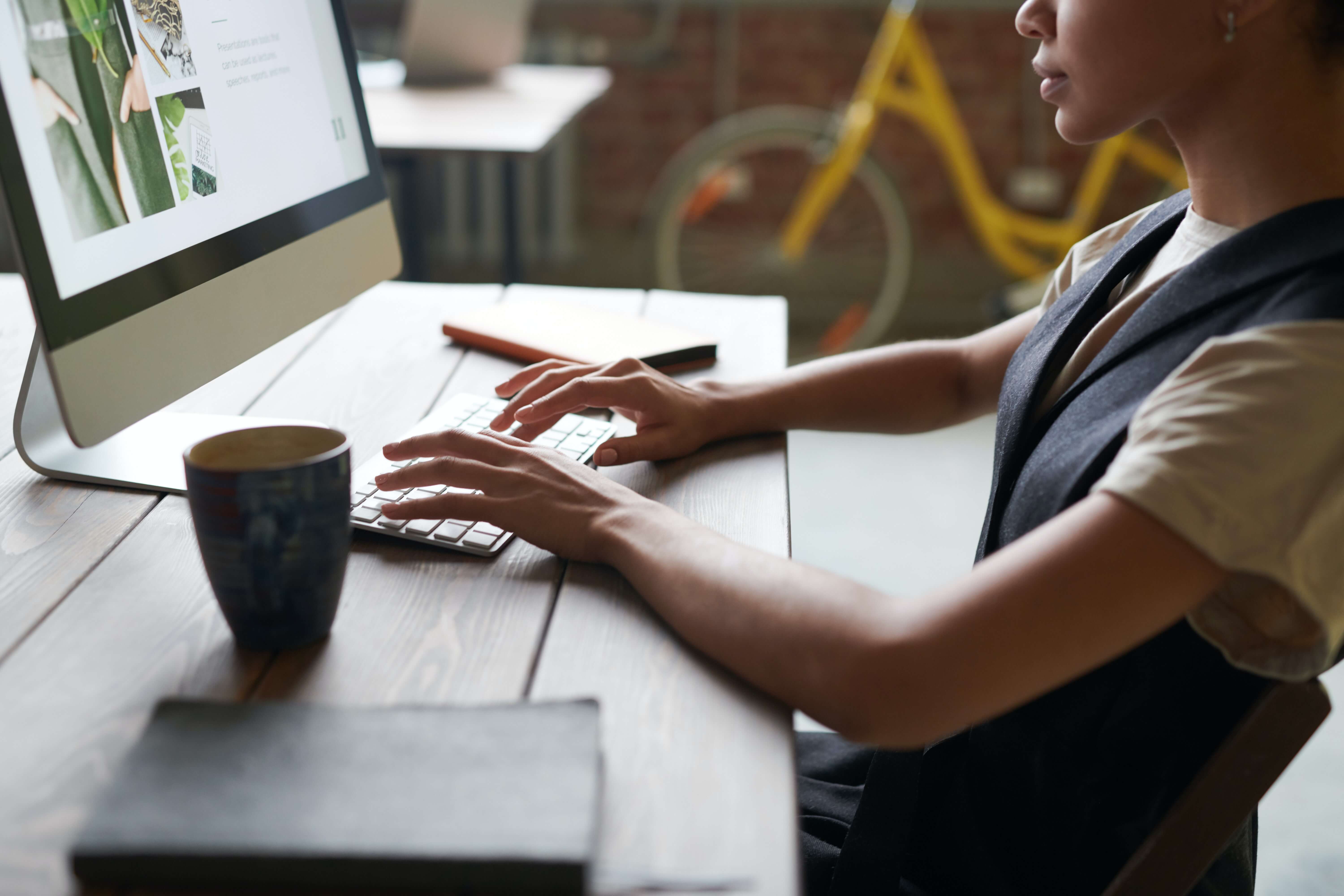 Woman working sitting infront of a pc