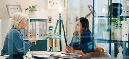 Picture: Two women talking in the office