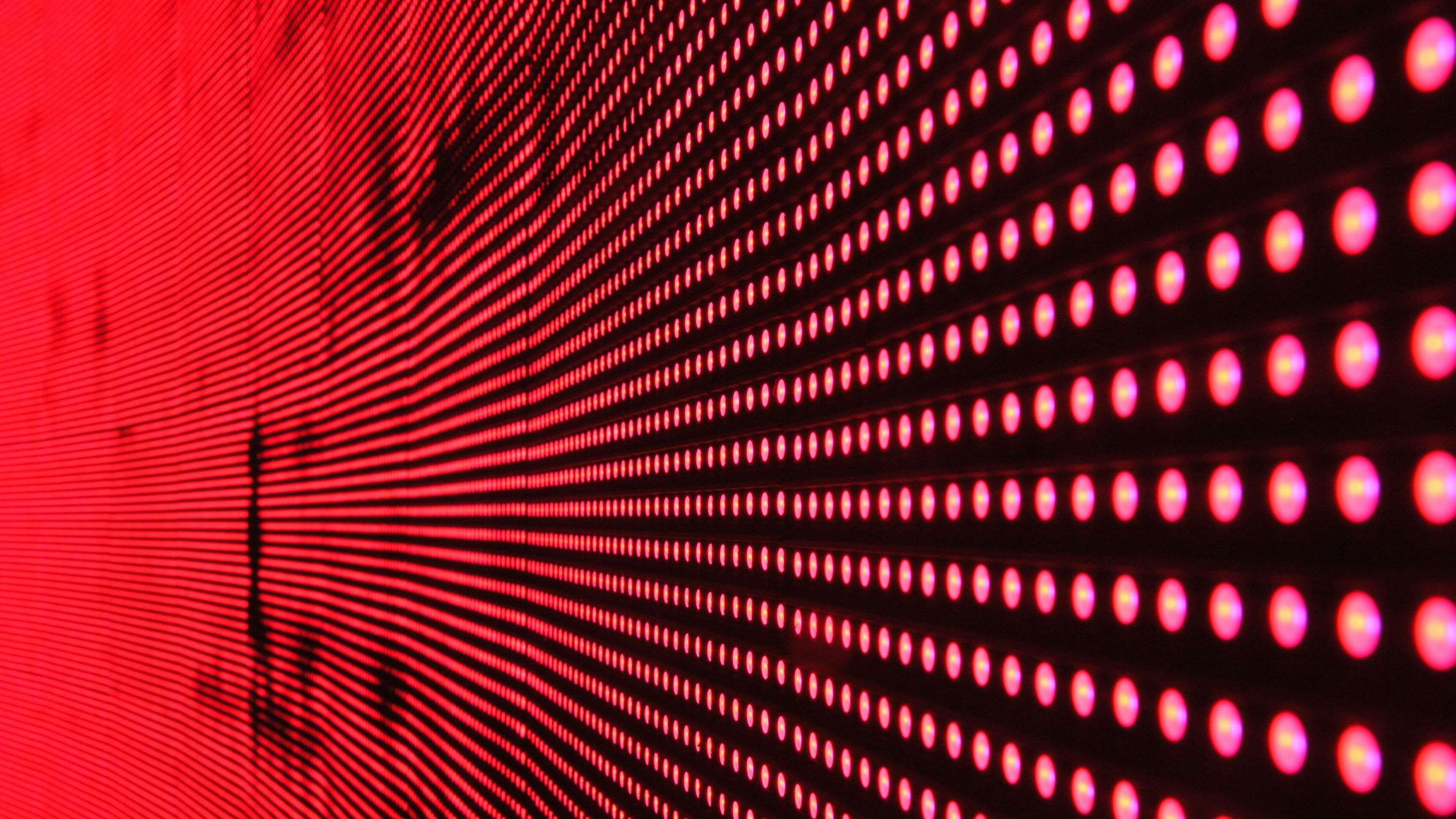 Photo: A light matrix on a black background and red dots